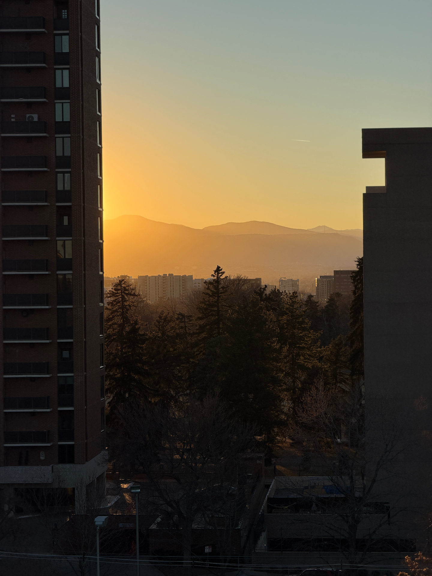 Foothills sunset framed by Denver buildings